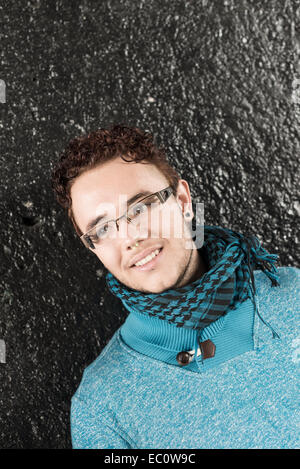 Beautiful young boy smiling in the sreet with glasses Stock Photo