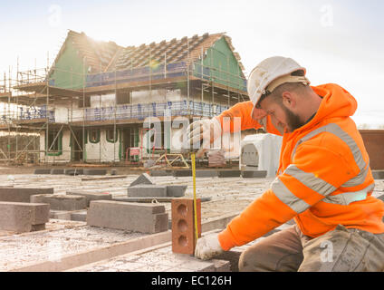 A builder working on a building site Stock Photo