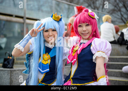 Girls dressed as anime characters pose at a cosplay gathering. Stock Photo