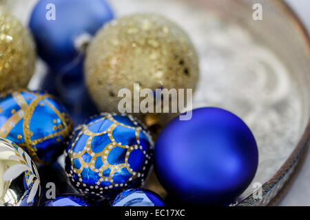 Blue and gold Christmas decorations on a silver tray Stock Photo