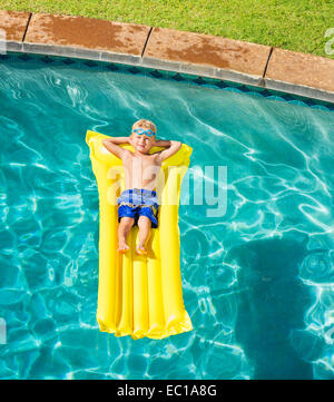 Boy on Float Tube in Swimming Pool Stock Photo - Alamy
