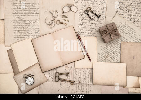 antique accessories, open book and old handwritten letters. nostalgic background Stock Photo