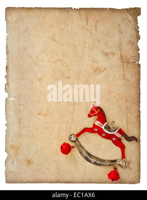 vintage christmas decoration rocking horse toy with aged paper page isolated on white background Stock Photo