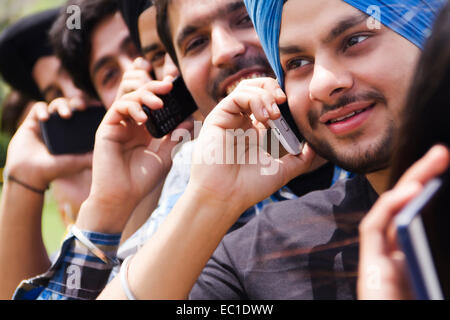 indian group crowds park  talking phone Stock Photo