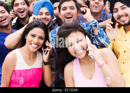 indian group crowds park  talking phone Stock Photo