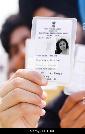 indian group crowds Election line with Voter id card Stock Photo