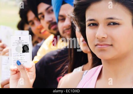 indian group crowds Election line with Voter id card Stock Photo