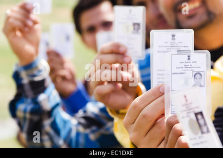 indian group crowds Election line with Voter id card Stock Photo