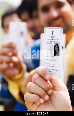 indian group crowds Election line with Voter id card Stock Photo