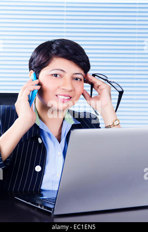 1 indian Business Woman office laptop working and talking phone Stock Photo
