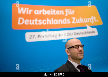 Cologne, Germany. 08th Dec, 2014. Secretary General of the Christian Democratic Union (CDU) Peter Tauber stands in front of the party motto 'We work for Germany's future' before the federal party convention in Cologne, Germany, 08 December 2014. The party convention takes place on Tuesday and Wednesday. Photo: ROLF VENNENBERND/dpa/Alamy Live News Stock Photo