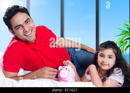 indian father with child saving money Stock Photo