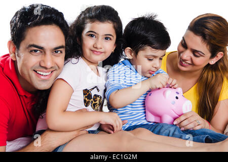 indian Parents with children saving money Stock Photo