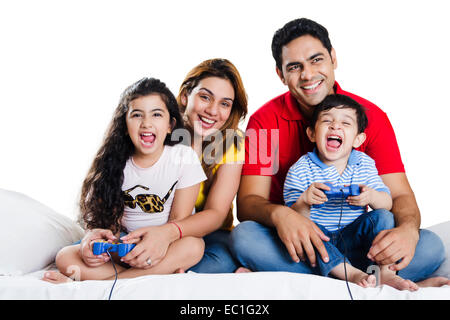 indian Parents with children playing Video Game Stock Photo