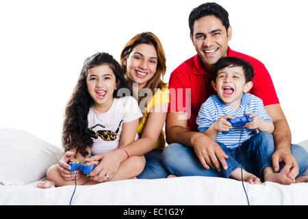 indian Parents with children playing Video Game Stock Photo