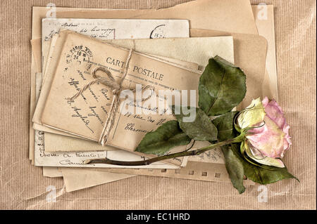dried rose flower and old letters. vintage postcards and envelopes. scrapbook Stock Photo