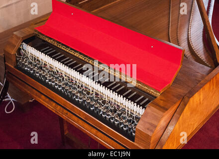 UAV Harpsichord. Goble two-manual harpsichord made in 1970, being played by a new MIDI-driven U.A.V. (Unmanned Awesome Virtuoso) device that uses solenoids to depress the keys. Each solenoid has a thin metal pushrod with which it can push a key. Powered by MIDI and can be controlled from an Apple IPhone etc. Developed and used in performance by virtuoso solo oboist Malcom Messiter Stock Photo