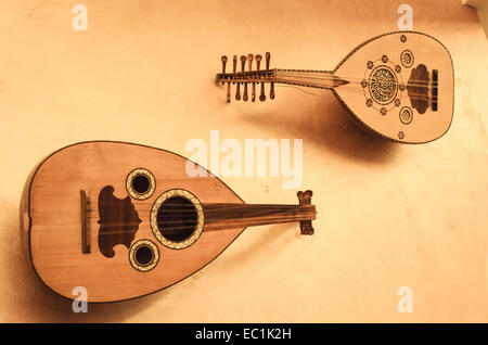 2 Ouds on display. From Damascus, Syria. Showing respectively 7 and 5 pairs of strings (the ÔdoublesÕ sounding sympathetically). Common across the Middle East, the precursor of the western lute. The name oud (or ud) derives from the Arabic for 'wood', and this refers to the strips of wood used to make its rounded body. Stock Photo