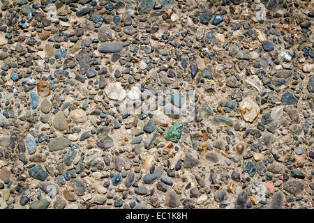 A fragment of a fence made of small colored stones ( the background image). Stock Photo