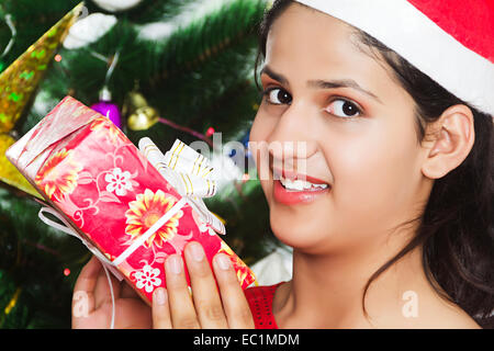 one indian girl Christmas Festival  showing gift Stock Photo