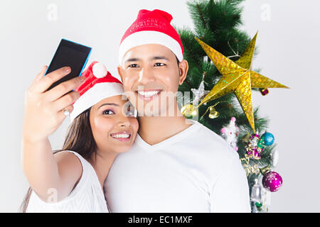 indian couple Christmas Festival phone Photography Stock Photo