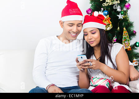 one indian couple Christmas Festival chatting phone Stock Photo