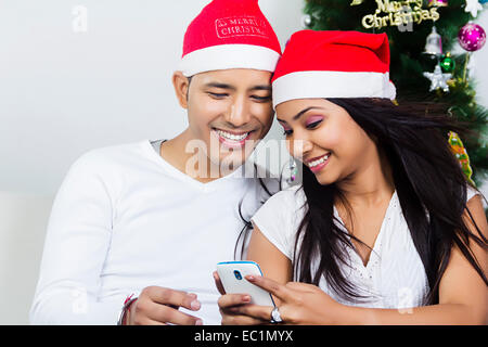 one indian couple Christmas Festival chatting phone Stock Photo
