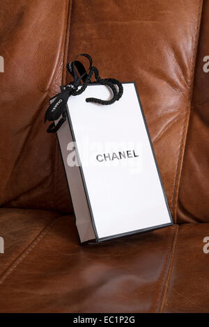 black and white Chanel perfume gift wrapped carrier bag laying on