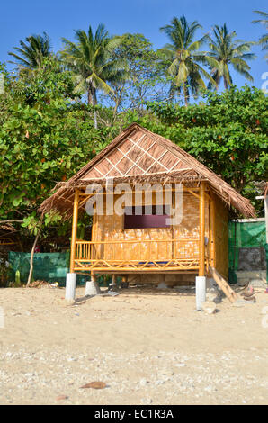 Bamboo beach hut on stilts, with palm trees in background, Koh Lanta, Thailand Stock Photo