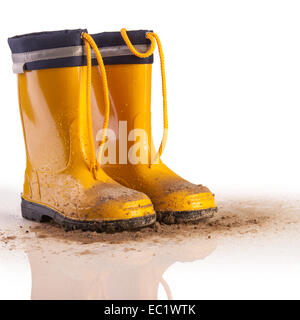 Yellow rubber boots for kids on white background Stock Photo