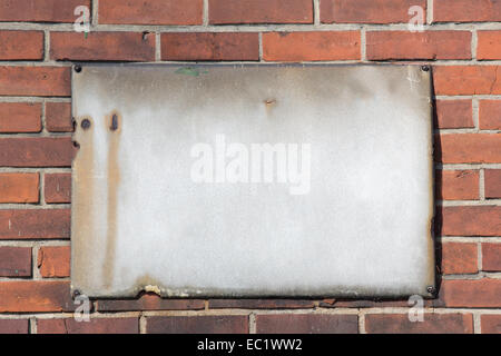 blank retro rusty metal sign on brick wall Stock Photo