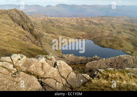 Stickle Tarn and Pavey Arc seen from the top of Harrison Stickle in the Langdale Pikes, Lake District, Cumbria, England, UK. Stock Photo