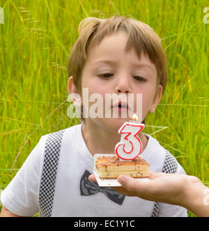 One kid at three years anniversary in nature Stock Photo