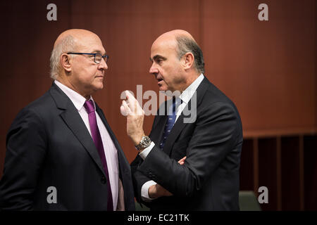 French Foreign Minister Michel Sapin (L) and Spanish Economy Minister Luis de Guindos  at the start of Eurogroup with European Finance ministers meeting at EU council headquarters in Brussels, Belgium on 08.12.2014 On the agenda of the session is assessment of the euro area member states‘ draft budgetary plans. The economy and finance ministers of the Eurozone will discuss also Greece (fifth review and follow up arrangements), Portugal (first post-programme surveillance report), Ireland (second post-programme surveillance mission), Stimulating investments and structural reforms. by Wiktor Dabk Stock Photo