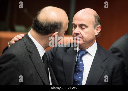 EU Commissioner in charge of Economic and Financial Affairs, Taxation and Customs Union, Pierre Moscovici (L) and Spanish Economy Minister Luis de Guindos  at the start of Eurogroup with European Finance ministers meeting at EU council headquarters in Brussels, Belgium on 08.12.2014 On the agenda of the session is assessment of the euro area member states‘ draft budgetary plans. The economy and finance ministers of the Eurozone will discuss also Greece (fifth review and follow up arrangements), Portugal (first post-programme surveillance report), Ireland (second post-programme surveillance mis Stock Photo
