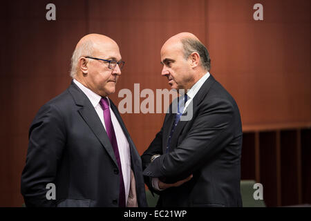 French Foreign Minister Michel Sapin (L) and Spanish Economy Minister Luis de Guindos  at the start of Eurogroup with European Finance ministers meeting at EU council headquarters in Brussels, Belgium on 08.12.2014 On the agenda of the session is assessment of the euro area member states‘ draft budgetary plans. The economy and finance ministers of the Eurozone will discuss also Greece (fifth review and follow up arrangements), Portugal (first post-programme surveillance report), Ireland (second post-programme surveillance mission), Stimulating investments and structural reforms. by Wiktor Dabk Stock Photo