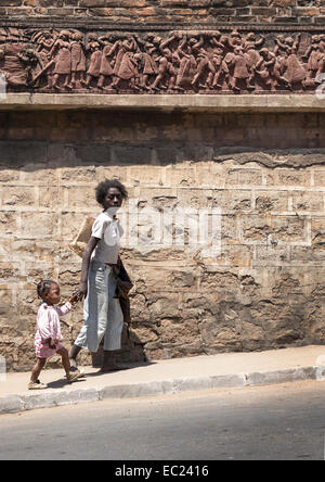 Woman walking with child in Antananarivo Madagascar Stock Photo