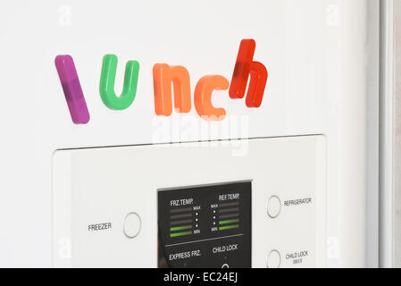 The word 'lunch' spelled out in fridge magnets on the door of a fridge. Stock Photo