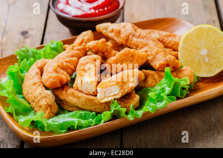 sticks breaded chicken with lemon Stock Photo