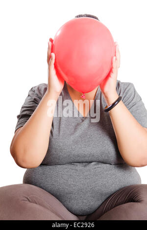 indian Obese  Lady Hiding Balloon Stock Photo