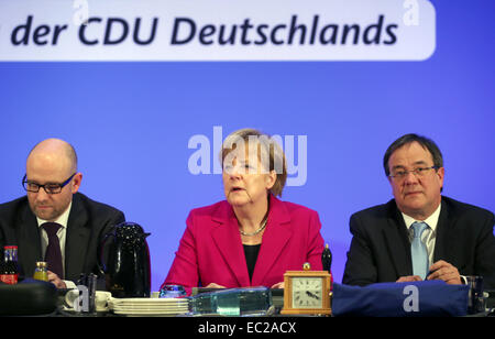 Cologne, Germany. 08th Dec, 2014. Chancellor Angela Merkel (C) opens the CDU federal party convention next to CDU state party leader of North Rhine-Westphalia Armin Laschet (R) and Secretary General of the Christian Democratic Union (CDU) Peter Tauber (L) in Cologne, Germany, 08 December 2014. The party convention takes place on Tuesday and Wednesday. Photo: OLIVER BERG/dpa/Alamy Live News Stock Photo
