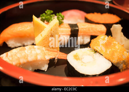 Closeup sushi set on black plate, stock photo Stock Photo