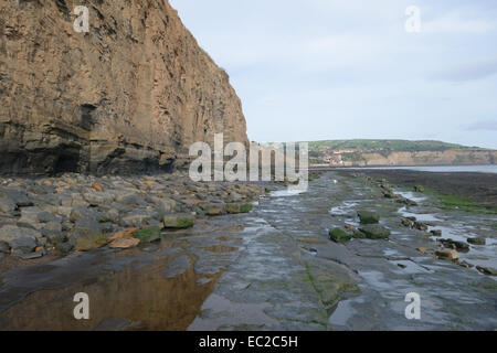 Robin Hood's Bay, a small fishing village and coastal bay with a Jurassic cliff coastline at low tide on a fine day in autumn, N Stock Photo