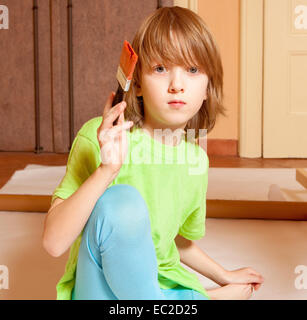 Portrait of a Boy Painting with Red Color Stock Photo