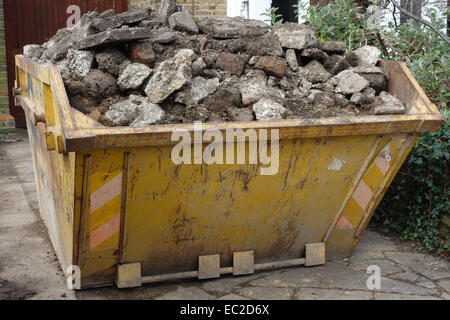 Skip Building Rubble A building skip full of rubble in a street in Newquay Town centre in ...