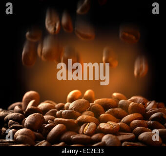 Brown coffee beans falling down on black background Stock Photo