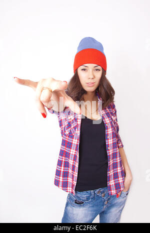 Cute hipster teenage girl with beanie hat posing looking at camera Stock Photo