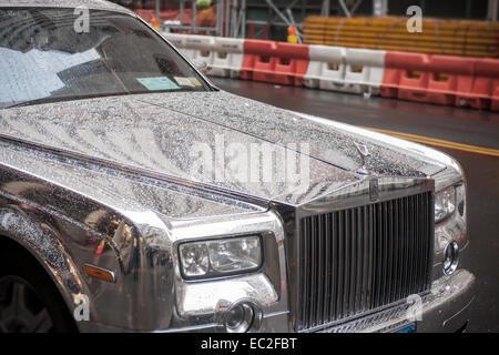 A silver, highly reflective Rolls-Royce automobile is parked in Lower Manhattan in New York on Wednesday, December 3, 2014. (© Richard B. Levine) Stock Photo