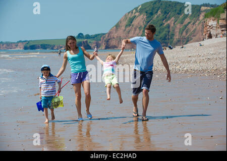 Family on the beach at Sidmouth on holiday having fun Stock Photo
