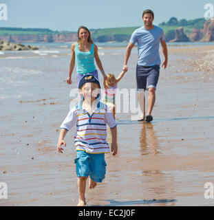 Family on the beach at Sidmouth on holiday having fun Stock Photo